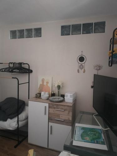 a room with a desk and a bed and a table at KAZANNa in Sainte-Clotilde