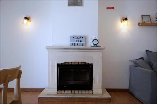 a living room with a fireplace with a tv at Casa da Praia - Manta Rota in Manta Rota
