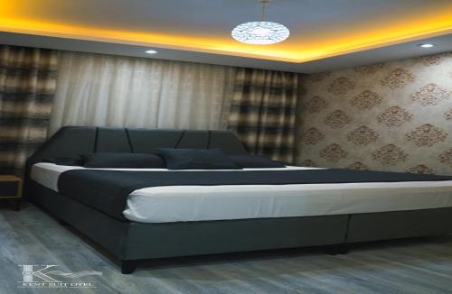 a bedroom with a large bed in a room at Mersin Kent Suit Hotel in Mezitli