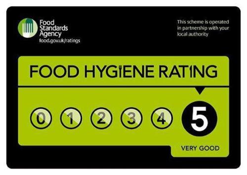 a green food hygiene rating sign on a sticker at The Hindes Hotel in Harrow