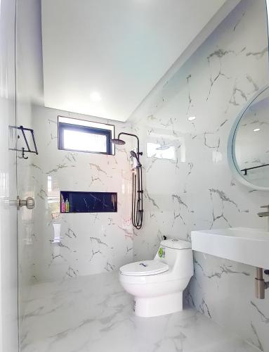 a white bathroom with a toilet and a sink at Level UP pool villa Rayong in Rayong