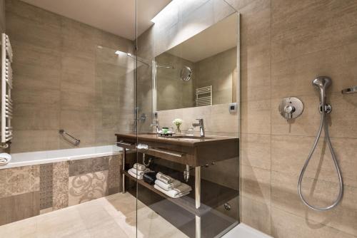 a bathroom with a sink and a shower at Hotel Plaža Duće in Duće