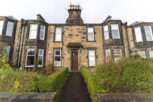 an old brick building with a door in front at Forth View Apartment in Stirling