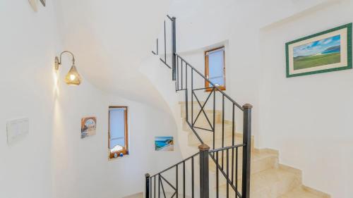 a staircase in a home with two windows at Villa Panorama, Kalkan, Private Pool, Panoramic Sea View in Kalkan