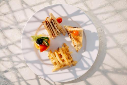 a white plate with food on a table at Seti Abu Simbel Lake Resort in Abu Simbel
