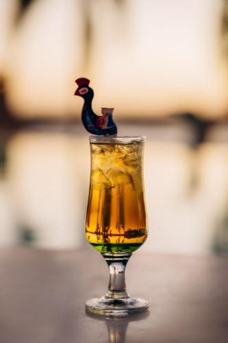 a wine glass with a rooster on top of it at Seti Abu Simbel Lake Resort in Abu Simbel