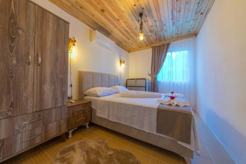 a bedroom with a large bed and a wooden ceiling at Ceren Villa Akyaka Daily Weekly Rentals in Mugla