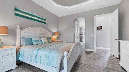a bedroom with a large bed with blue pillows at Luxury Contemporary Style House on Charlotte Harbor Area Charlotte County House 5841 in Placida