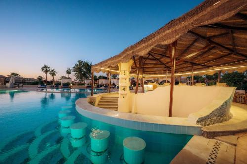 a pool at a resort with a swimming deck at Seti Abu Simbel Lake Resort in Abu Simbel