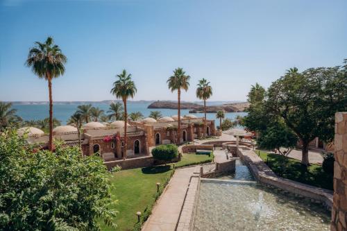 a view of a mansion with palm trees at Seti Abu Simbel Lake Resort in Abu Simbel