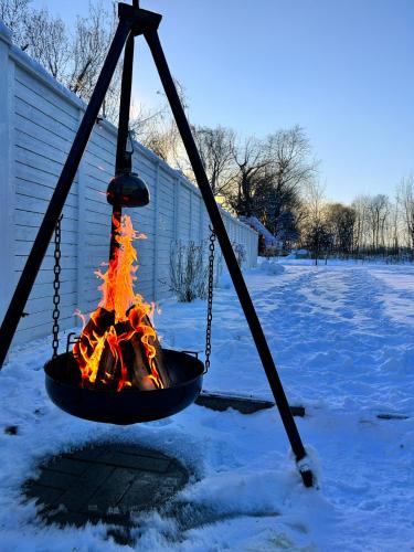 a fire in a swing in the snow at Guest house - Northern tealight in Rovaniemi