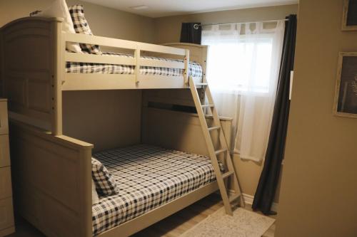a bedroom with two bunk beds and a window at Hot Tub Relax Haven with Firepit and Gameroom in Kingston