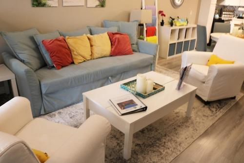 a living room with a couch and a table at Hot Tub Relax Haven with Firepit and Gameroom in Kingston