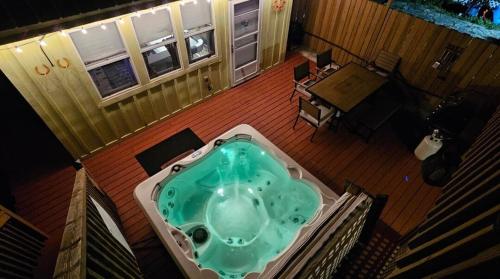 a jacuzzi tub sitting on a deck at Hot Tub Relax Haven with Firepit and Gameroom in Kingston