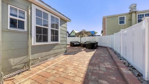 a patio with an umbrella next to a house at Charming Condo with City Views 5857 in Punta Gorda