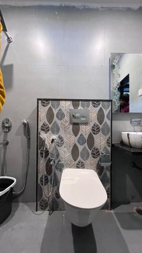 a bathroom with a toilet and a sink at Mithila - A Lovely & Peaceful 3 BHK Villa in Orchha