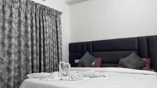 a bedroom with a bed with a black headboard at Mithila - A Lovely & Peaceful 3 BHK Villa in Orchha