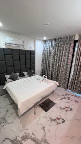 a bedroom with a large bed with a marble floor at Mithila - A Lovely & Peaceful 3 BHK Villa in Orchha