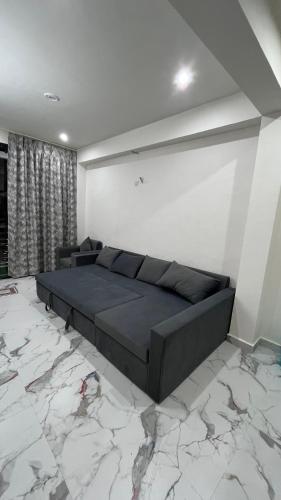 a bedroom with a bed and a marble floor at Mithila - A Lovely & Peaceful 3 BHK Villa in Orchha