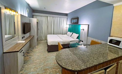 a hotel room with a bed and a bathroom at Hafez Hotel Apartments - Al Ras Metro Station in Dubai