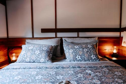 a bedroom with a large bed with two pillows at Cottage 2 - The Row in Forest Grove
