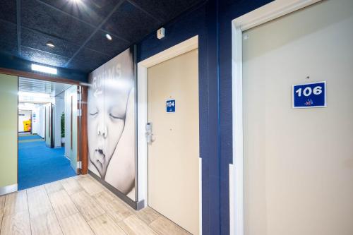 a hallway of an office with a sign on the wall at ibis budget London Barking in Barking