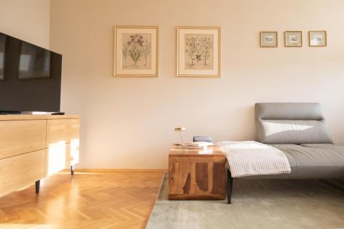 a living room with a couch and a coffee table at Husova 87 Rosewood Suite in Liberec