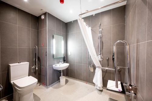 a bathroom with a toilet and a sink and a shower at ibis budget London Barking in Barking