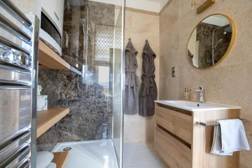 a bathroom with a sink and a shower at Husova 87 Rosewood Suite in Liberec