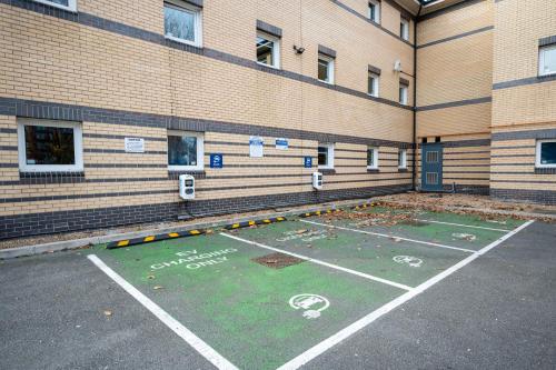 a parking lot in front of a building at ibis budget London Barking in Barking