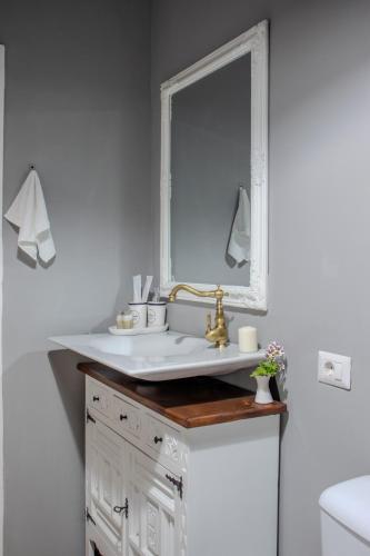 a bathroom with a sink and a mirror at Old Town by Humpback in Craiova
