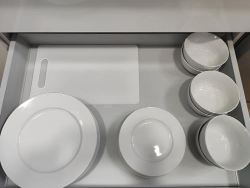 a group of plates and bowls on a shelf at Apartamentos VALDECILLA nuevos in Santander