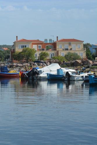 a group of boats are docked in the water at Palaiologou Panorama Apartments in Mantamádos