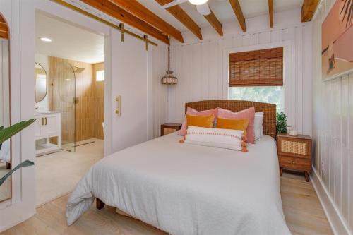 a bedroom with a bed with orange and white pillows at Orlando Home 6430: Purpose-Driven A-Frame Vacation Home in Clermont