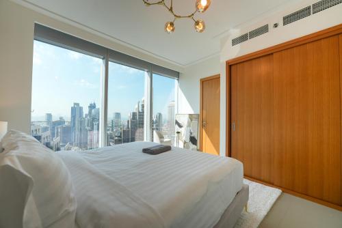 a bedroom with a bed and a large window at Luxurious 1BR in Opera Grand 5 mins walk to Burj Khalifa in Dubai