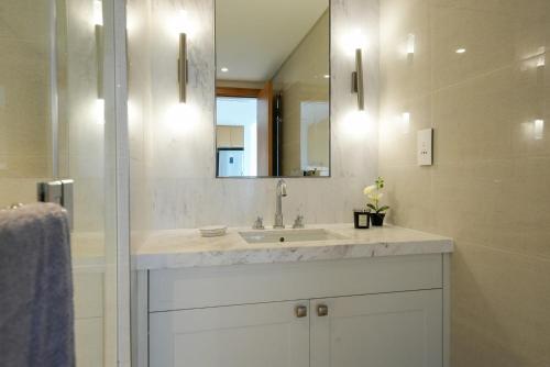 a bathroom with a sink and a mirror at Luxurious 1BR in Opera Grand 5 mins walk to Burj Khalifa in Dubai