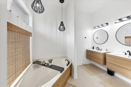 a bathroom with a tub and a sink and a mirror at Charlotte County Villa 5878: Waterfront Pool Spa Home in Punta Gorda