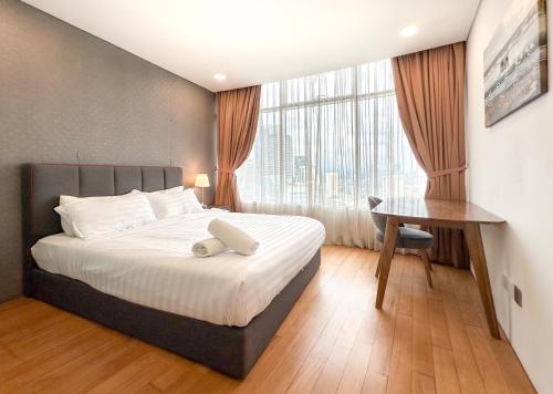 Postel nebo postele na pokoji v ubytování Vortex KLCC Vibes