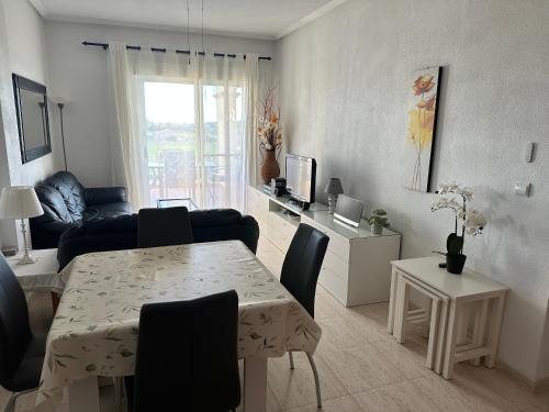 a living room with a dining table and a living room with a couch at Appartement Dolores in Dolores