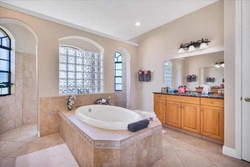 a large bathroom with a tub and a sink at Cape Coral Villa 1001: Private Pool Tranquil Stay in Matlacha