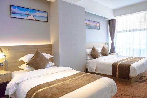 a hotel room with two beds and a window at 厦门中山海滨酒店 in Xiamen