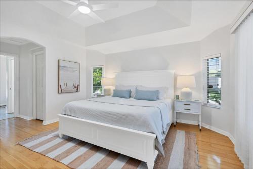 a white bedroom with a white bed and a window at Charlotte County Villa 5893: Your Perfect Getaway in Punta Gorda