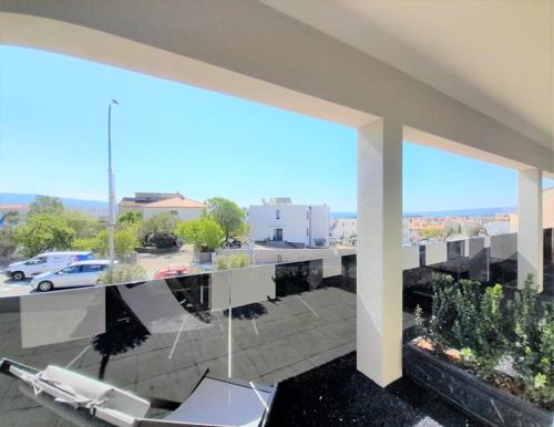 a balcony with a view of a parking lot at Villa LuiSole in Krk
