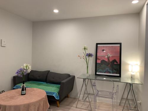 a living room with a couch and a table at Sky Stars Essential Reserve in Auckland