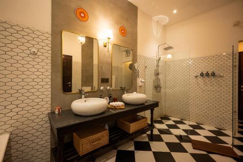 a bathroom with two sinks and a checkered floor at Riverdale Bungalow - Film Location For 'Bridge On The River Kwai' in Kandy