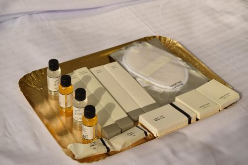 a tray with bottles ofmetics sitting on a bed at شقق دار الزيني - Dar Alzainy Apartments in Baghdad