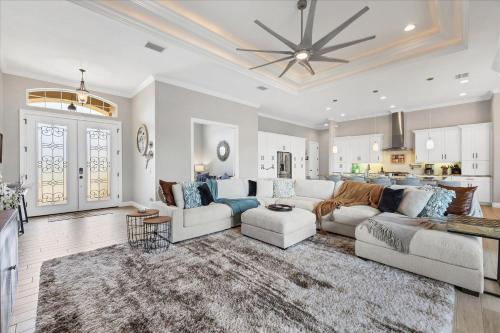 a living room with white furniture and a kitchen at Charlotte County Villa 5913: Private Pool Spa Oasis in Punta Gorda