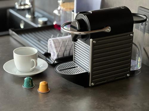 a coffee maker with a cup on a table at Apartmány Šestka in Staré Město
