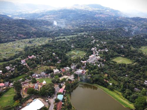 an aerial view of a town with a lake at Paradise Point Nature Cabana Kandy in Kande