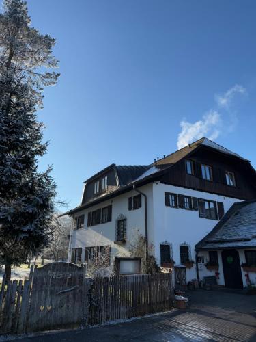 a white building with a black roof at Esterer in Grödig